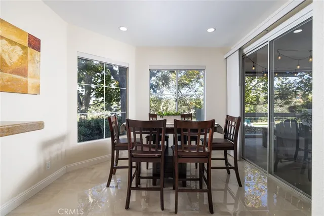 a view of a dining room with furniture and front door