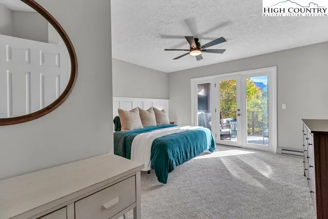 a bedroom with a bed and a chandelier