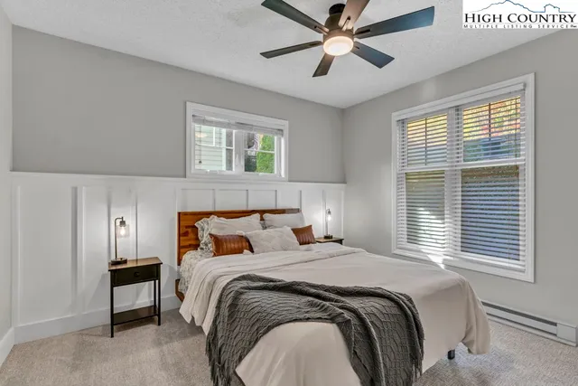 a bed room with a bed and a painting on the wall