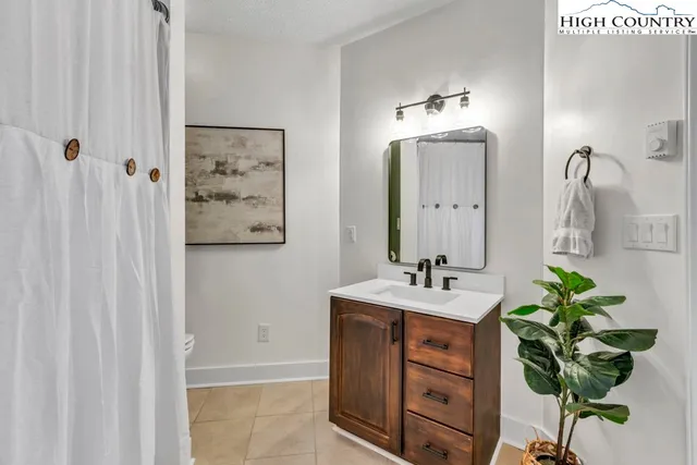 a bathroom with a shower curtain and a toilet