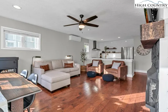 a living room with furniture fireplace and flat screen tv
