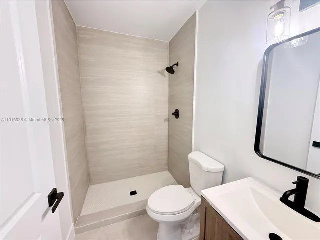 a white toilet sitting next to a bathroom sink