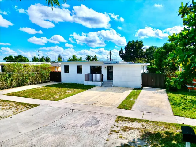 a view of backyard of house with outdoor seating