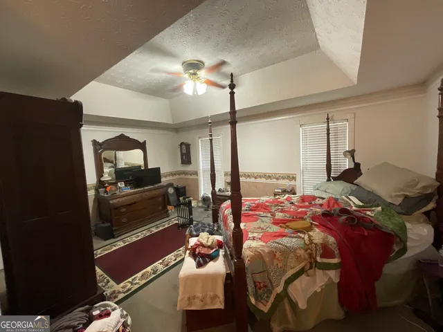 a bed room with a bed and a television