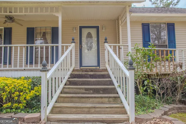 a view of a livingroom with furniture wooden floor and a porch
