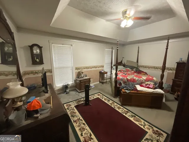 a bedroom with furniture and a chandelier