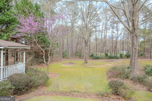a kitchen with granite countertop lots of clutter and stainless steel appliances