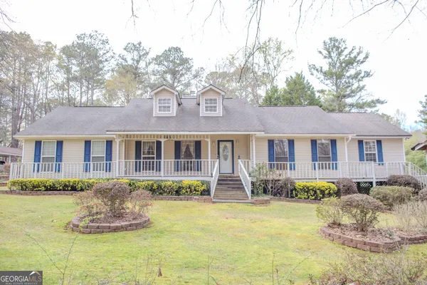 a front view of a house with yard and green space
