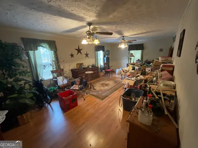 a view of a livingroom with furniture window and wooden floor