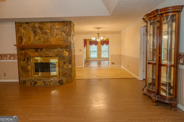 a living room with furniture a fireplace and a floor to ceiling window