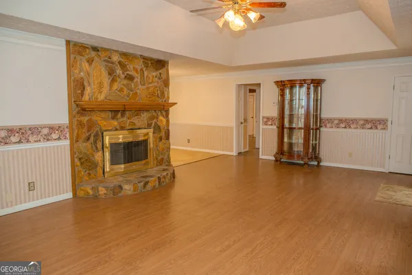 a living room with furniture gym equipment and a flat screen tv