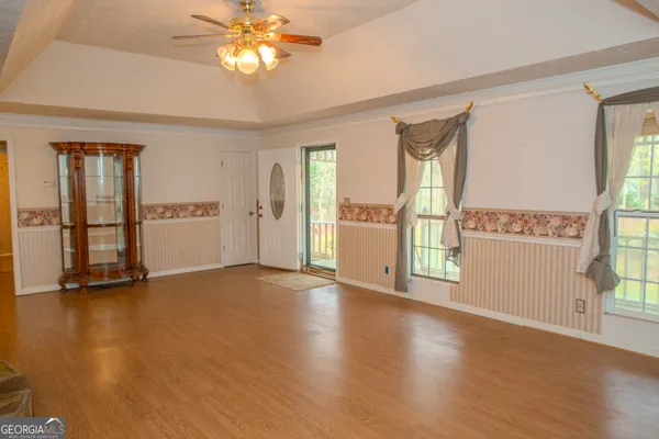 a view of a livingroom with furniture window and wooden floor