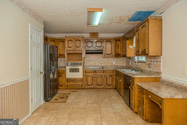 a bathroom with a granite countertop sink toilet and a mirror