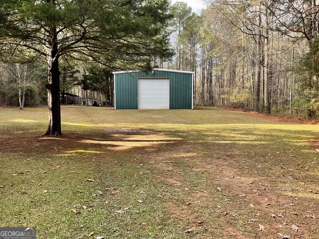 a view of a house with a yard and tree s