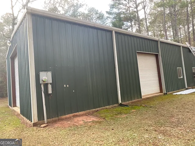 a view of a house with backyard space and wooden fence