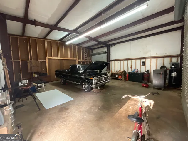 a living room with furniture gym equipment and a chandelier