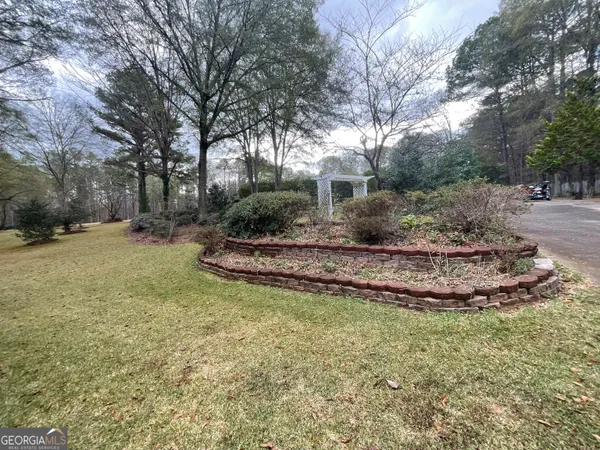 a view of a house with backyard space and wooden fence