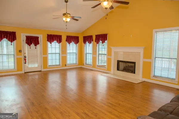a bathroom with a sink vanity granite tub and a mirror