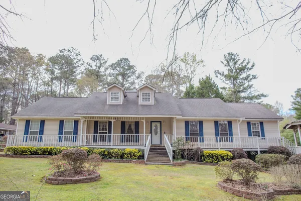 a front view of a house with a yard table and chairs