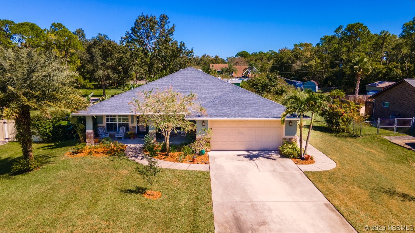 a view of a house with swimming pool and sitting area