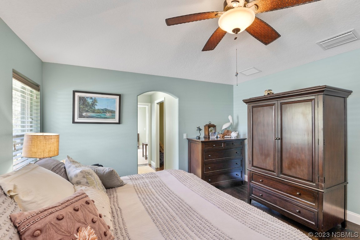 1815 Air Park Road Edgewater, FL 32132 - Photo 20 of 54 a bedroom with a bed and a chandelier