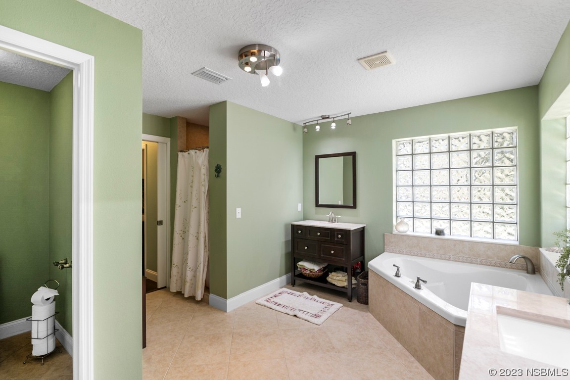 1815 Air Park Road Edgewater, FL 32132 - Photo 23 of 54 a spacious bathroom with a tub sink and mirror