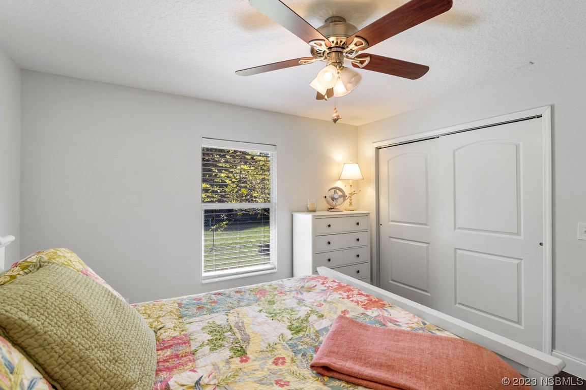 1815 Air Park Road Edgewater, FL 32132 - Photo 25 of 54 a bedroom with a bed and a chandelier