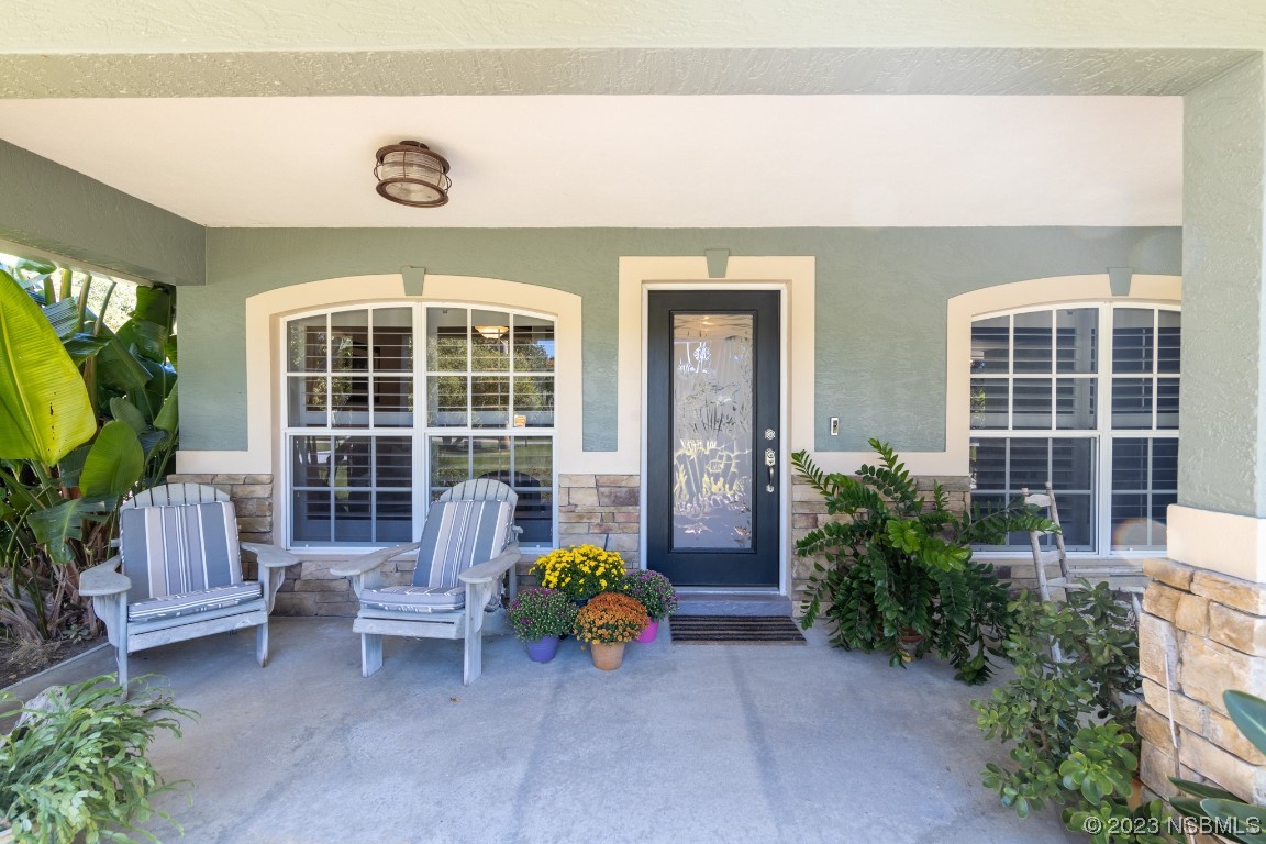 1815 Air Park Road Edgewater, FL 32132 - Photo 3 of 54 a view of front door of house with outdoor seating