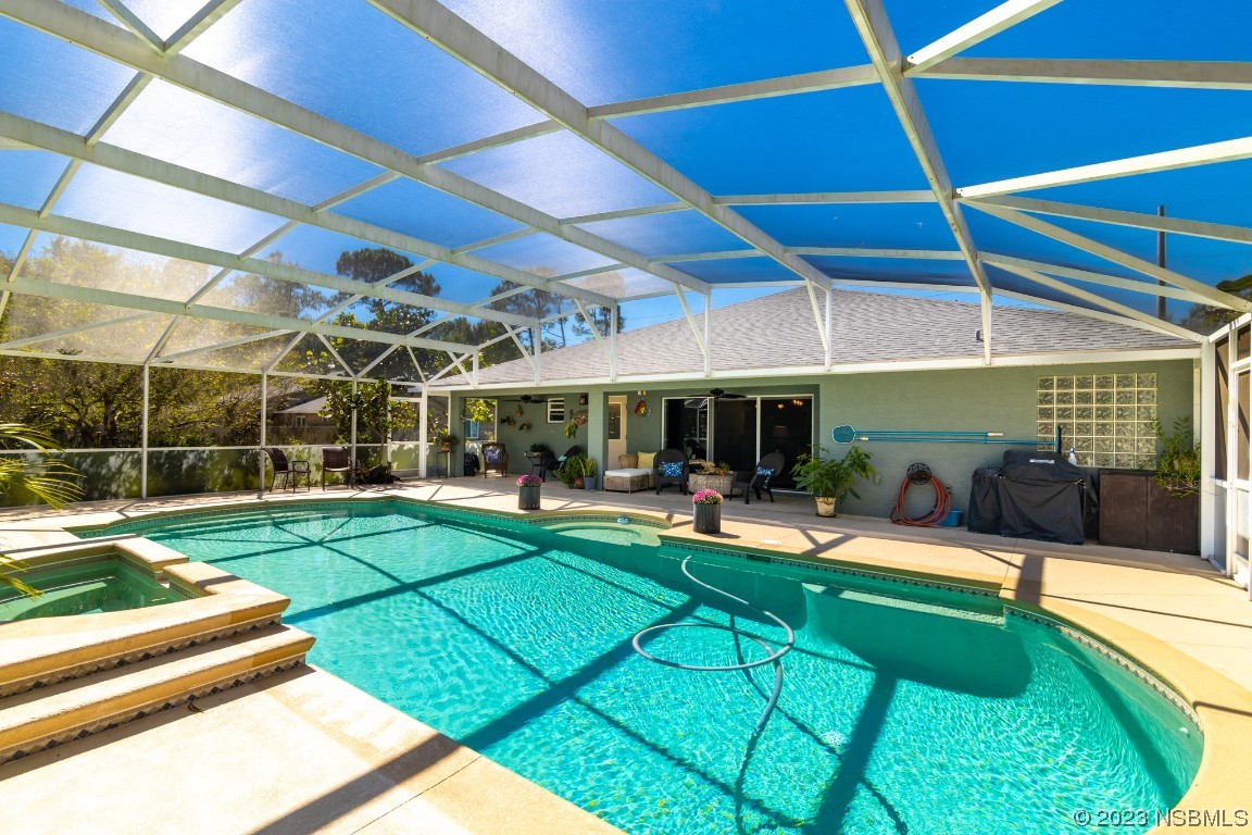 1815 Air Park Road Edgewater, FL 32132 - Photo 37 of 54 a view of a backyard with table and chairs under an umbrella