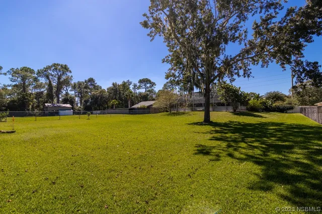 an aerial view of a house with a yard and garden space