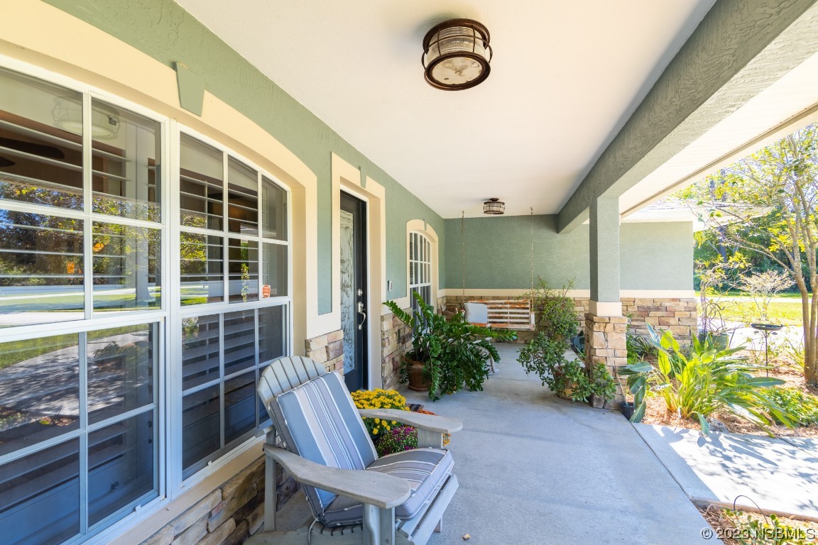 1815 Air Park Road Edgewater, FL 32132 - Photo 4 of 54 a balcony with furniture and a potted plant
