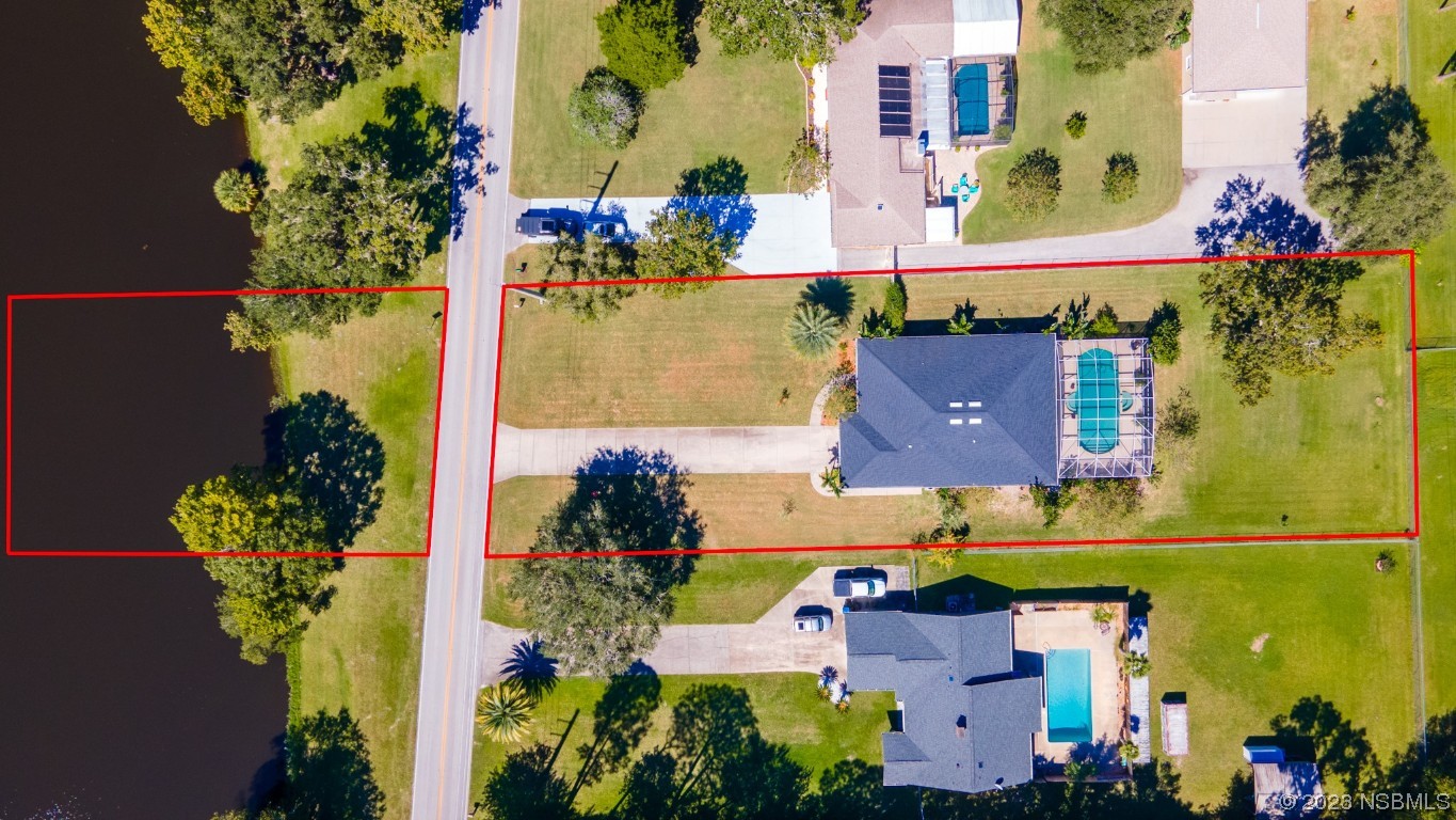 1815 Air Park Road Edgewater, FL 32132 - Photo 42 of 54 an aerial view of a house with a yard and garden space