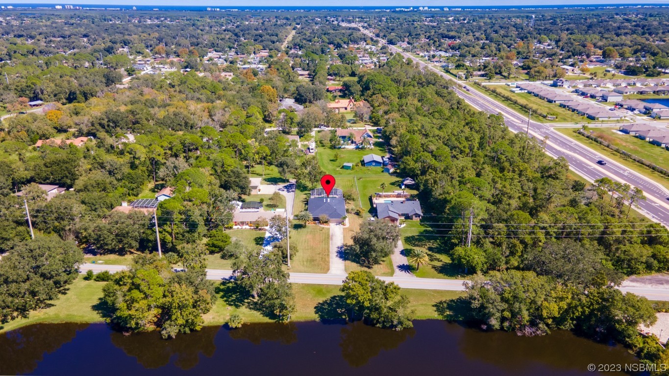 1815 Air Park Road Edgewater, FL 32132 - Photo 45 of 54 an aerial view of residential houses with outdoor space and trees
