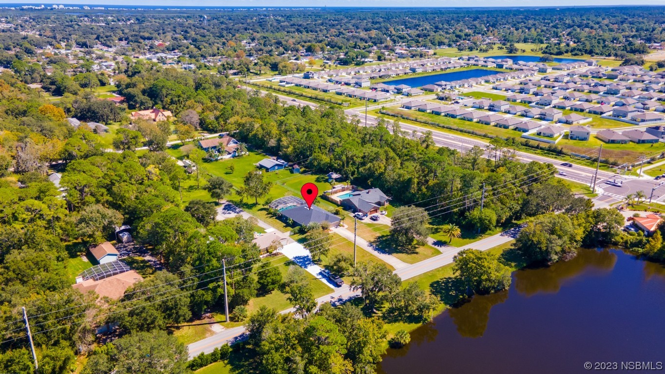 1815 Air Park Road Edgewater, FL 32132 - Photo 47 of 54 an aerial view of residential houses with outdoor space and trees