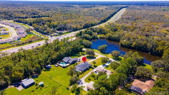 an aerial view of a house with swimming pool garden and patio