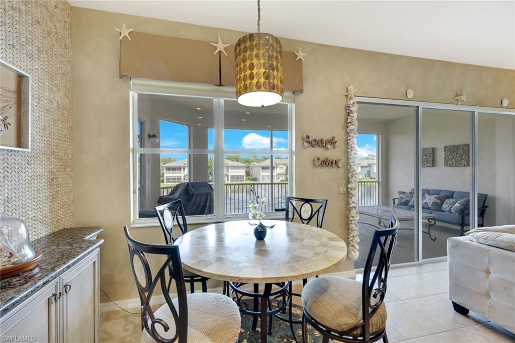 3530 Lansing Loop, Unit 202 Estero, FL 33928 - Photo 15 of 35 a view of a a dining room with furniture window and wooden floor