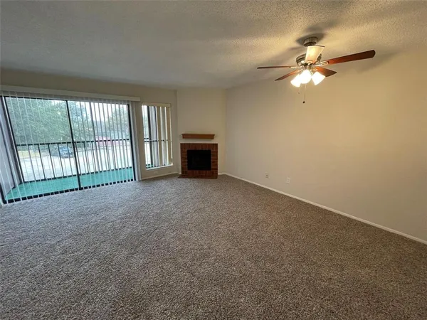 a view of a livingroom with an empty space and a ceiling fan