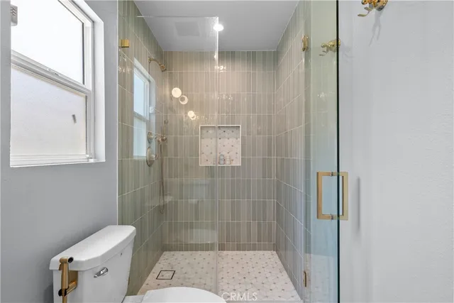 a bedroom with a bed and flat screen tv