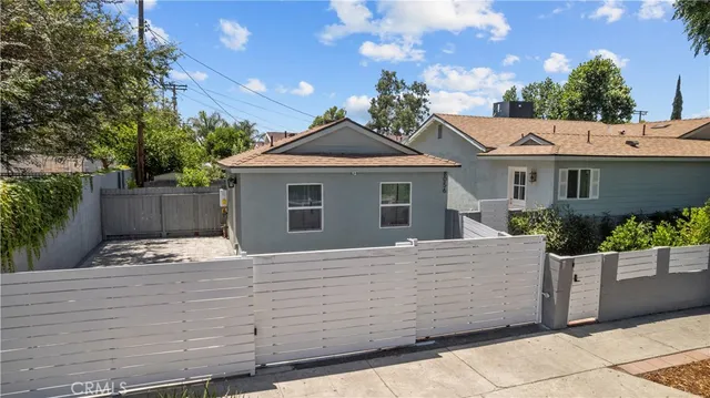 a backyard of a house with table and chairs