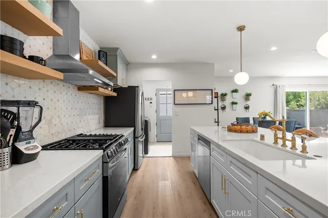 a large kitchen with stainless steel appliances granite countertop a stove and a large kitchen island