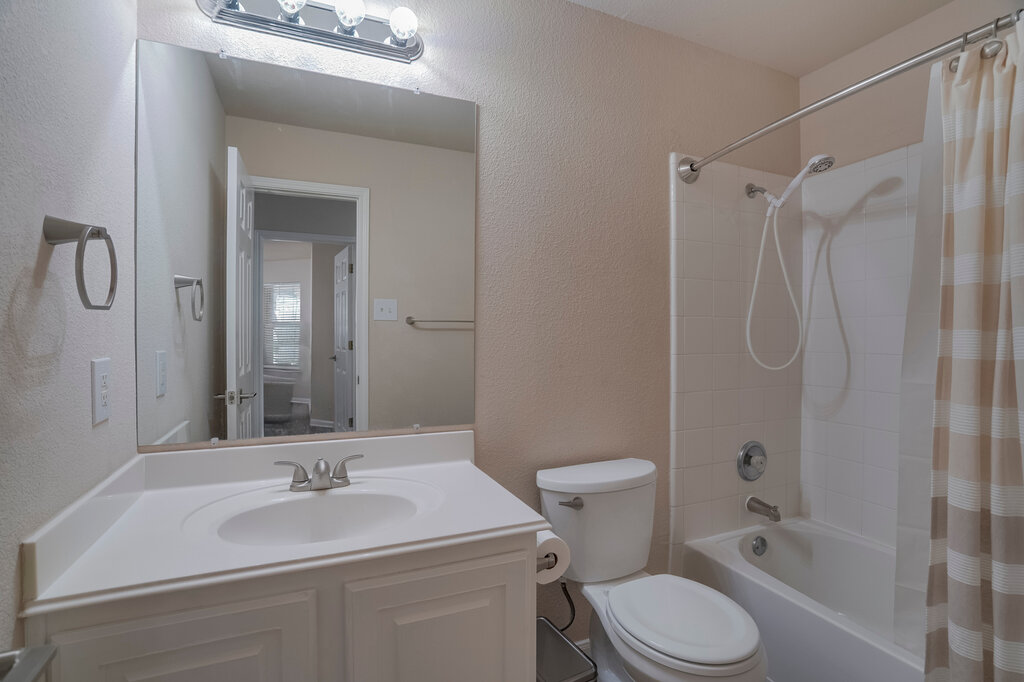 2724 Kickapoo Cavern Drive Pflugerville, TX 78660 - Photo 20 of 24 Well-lit bathroom features a vanity with ample counter space and a full shower-tub combination.