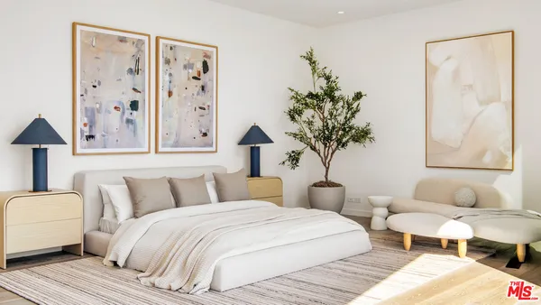 a bedroom with furniture and a large window