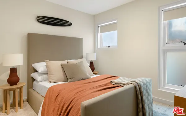 a bedroom with a bed and a lamp