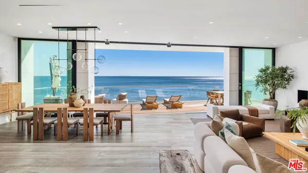 a living room with lots of furniture and a large window