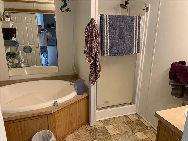a bathroom with a tub and a shower