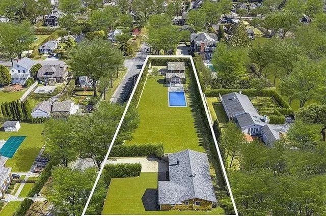 an aerial view of residential houses with yard