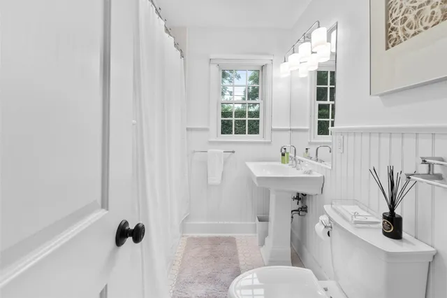 a bathroom with a sink a mirror and a toilet