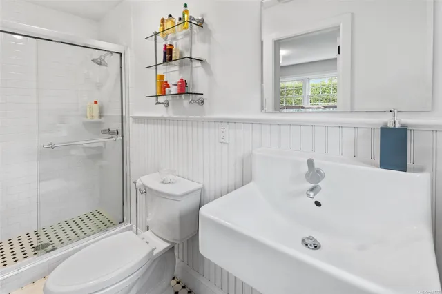 a bathroom with a sink a toilet and shower curtain