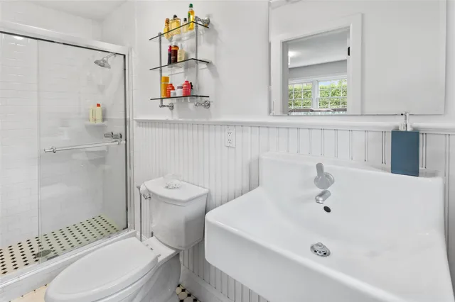 a bathroom with a sink a toilet and shower curtain