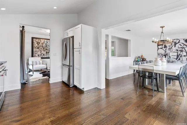 a view of kitchen with refrigerator stove and wooden floor
